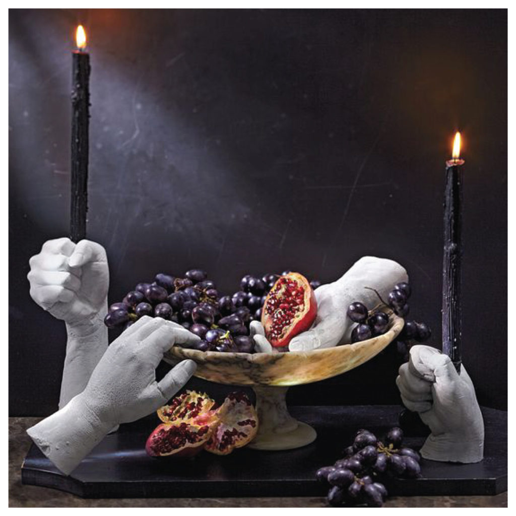 grapes with hand candle sticks